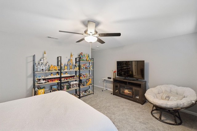 carpeted bedroom with visible vents, baseboards, and ceiling fan