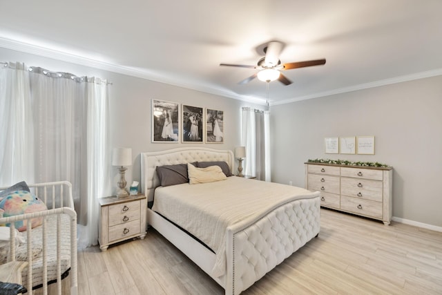 bedroom featuring a ceiling fan, baseboards, ornamental molding, and light wood-style floors