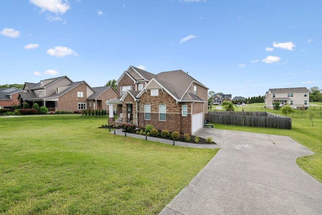 view of front of house with fence, driveway, a residential view, and a garage