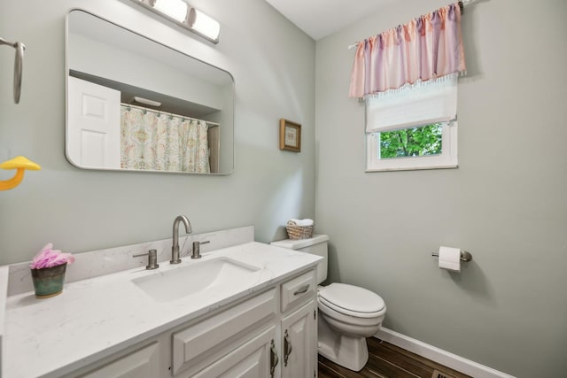 full bath with vanity, toilet, a shower with shower curtain, baseboards, and wood finished floors