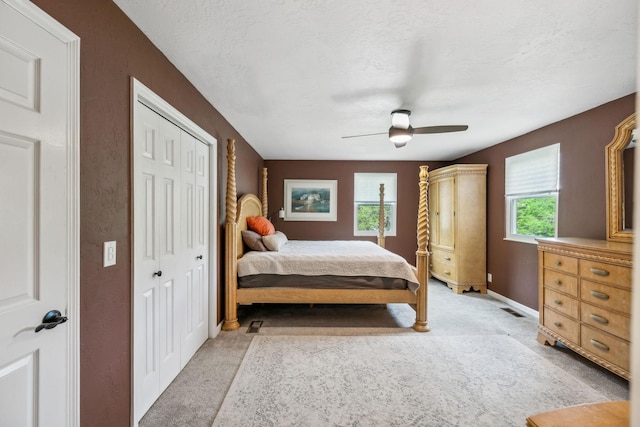 bedroom with a ceiling fan, baseboards, visible vents, and light carpet