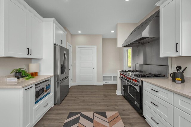231 Wolf Ridge Ln, Lynchburg, TN 37352 - kitchen featuring dark wood finished floors, white cabinets, under cabinet range hood, stainless steel appliances, and recessed lighting