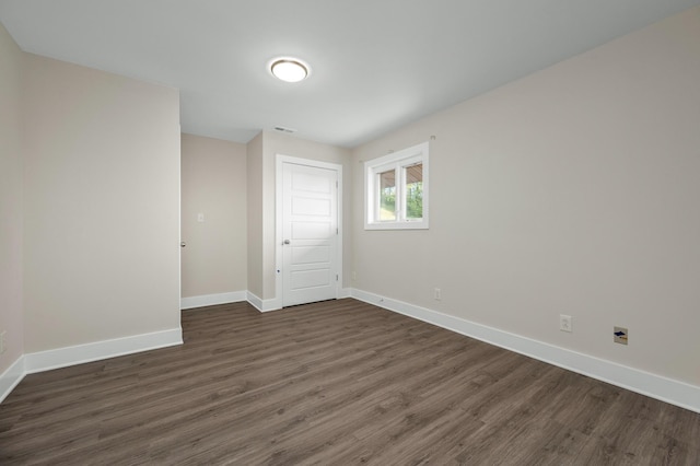 231 Wolf Ridge Ln, Lynchburg, TN 37352 - spare room with baseboards, visible vents, and dark wood-type flooring