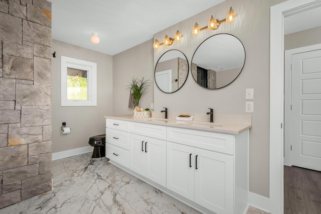 231 Wolf Ridge Ln, Lynchburg, TN 37352 - full bathroom with baseboards, a sink, marble finish floor, and double vanity