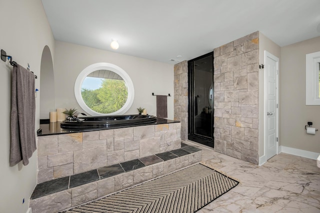 231 Wolf Ridge Ln, Lynchburg, TN 37352 - full bathroom featuring baseboards, a garden tub, marble finish floor, and a stall shower