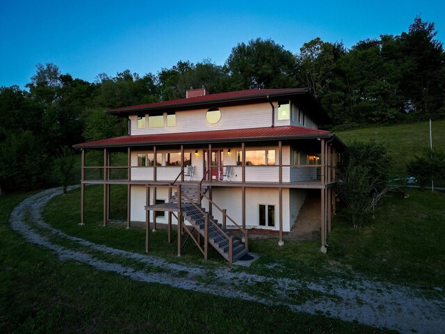 231 Wolf Ridge Ln, Lynchburg, TN 37352 - rear view of property featuring stairs, stucco siding, a yard, and a chimney