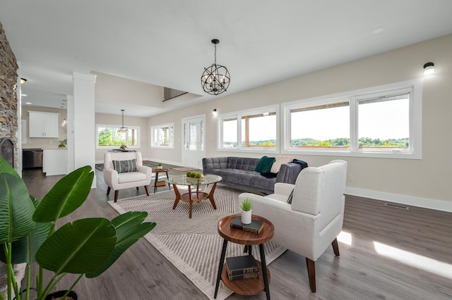 231 Wolf Ridge Ln, Lynchburg, TN 37352 - living area featuring baseboards, a notable chandelier, wood finished floors, and visible vents