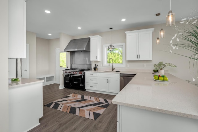231 Wolf Ridge Ln, Lynchburg, TN 37352 - kitchen with wall chimney range hood, a sink, dishwasher, range with two ovens, and dark wood-type flooring