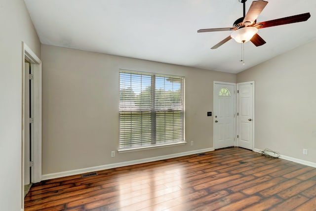 interior space featuring visible vents, a ceiling fan, baseboards, and wood finished floors
