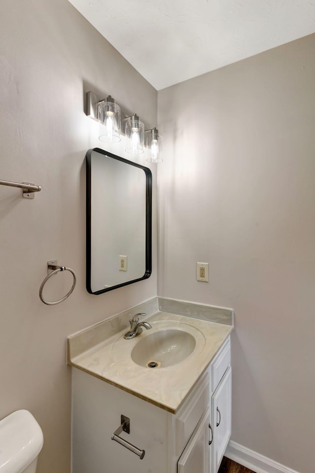 half bath with vanity and toilet