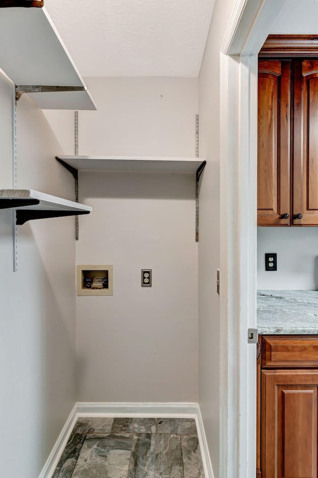 laundry area with laundry area, baseboards, and hookup for a washing machine