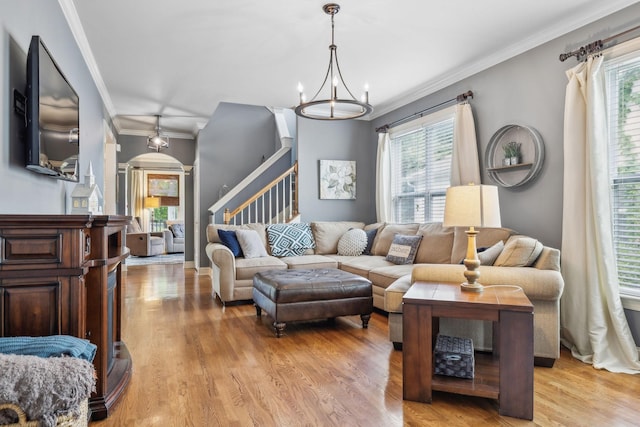 5028 Burke Trl, Nolensville, TN 37135 - living area featuring light wood-style floors, arched walkways, stairs, and ornamental molding