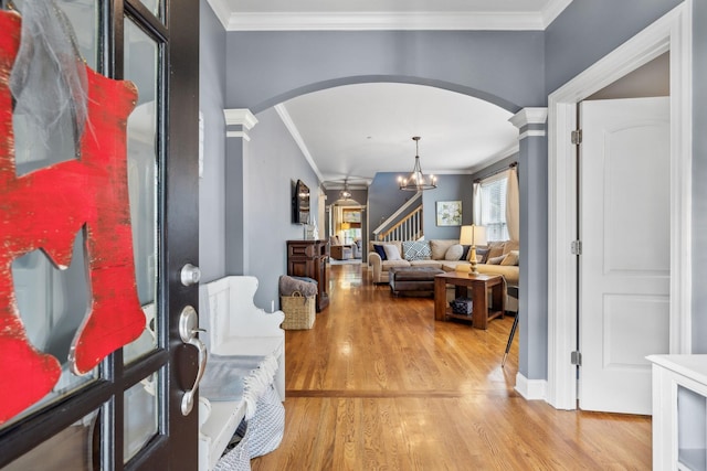 5028 Burke Trl, Nolensville, TN 37135 - foyer entrance with arched walkways, wood finished floors, an inviting chandelier, ornamental molding, and stairs