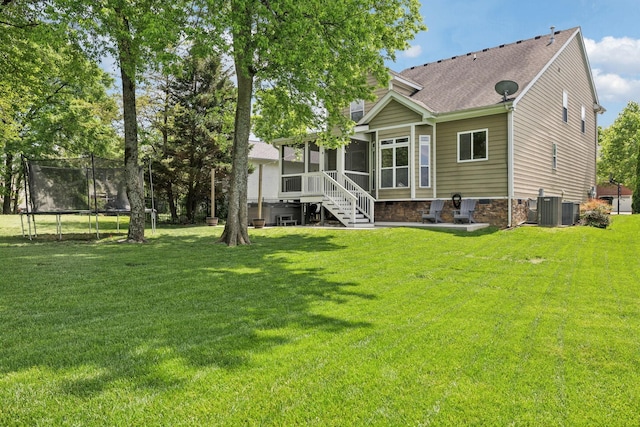 5028 Burke Trl, Nolensville, TN 37135 - rear view of house featuring a lawn, a trampoline, a sunroom, and roof with shingles