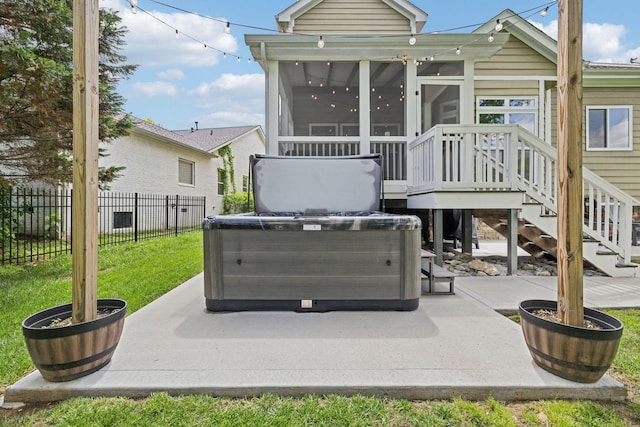5028 Burke Trl, Nolensville, TN 37135 - rear view of property featuring fence, a hot tub, a sunroom, a lawn, and a patio