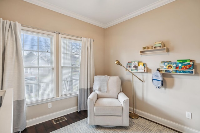 sitting room featuring visible vents, baseboards, crown molding, and wood finished floors