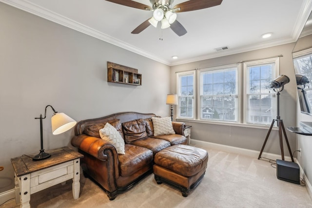 living room featuring crown molding, baseboards, ceiling fan, and carpet