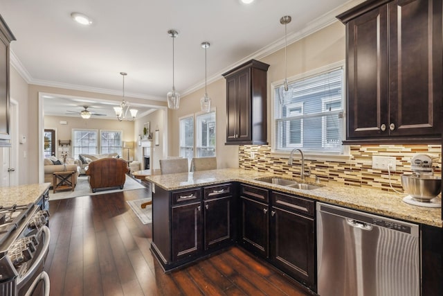 kitchen featuring a ceiling fan, open floor plan, a sink, dark wood finished floors, and stainless steel appliances