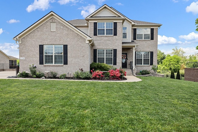 1108 Brixworth Dr, Spring Hill, TN 37174 - view of front facade with brick siding, fence, and a front yard