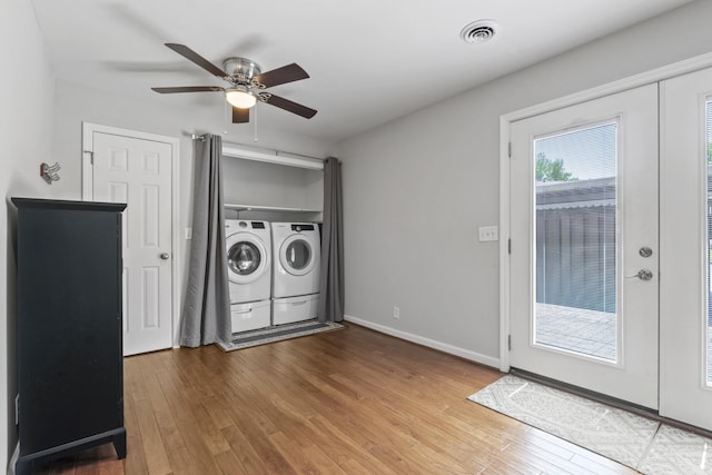 washroom featuring washer and dryer, laundry area, a ceiling fan, wood finished floors, and visible vents