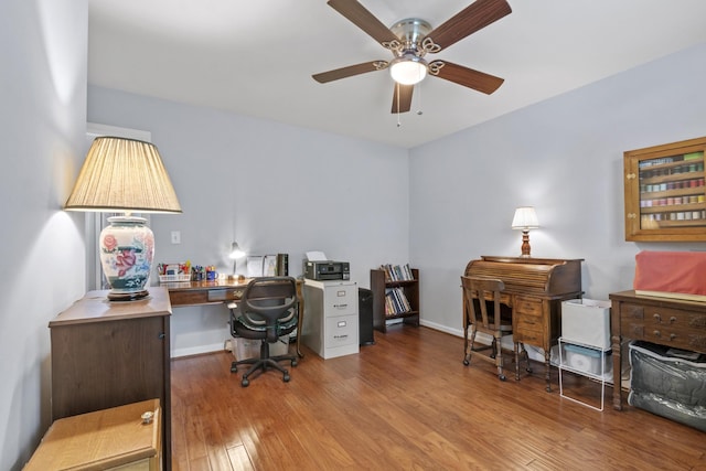 office space featuring baseboards, ceiling fan, and wood finished floors