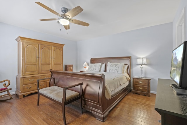 bedroom with baseboards, a ceiling fan, and light wood finished floors