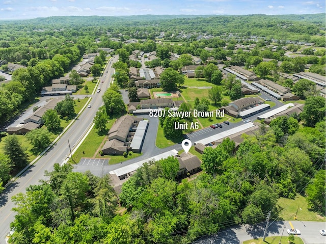 drone / aerial view featuring a residential view and a wooded view