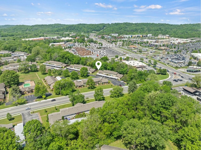 birds eye view of property featuring a view of trees