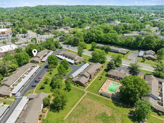 aerial view featuring a residential view and a wooded view
