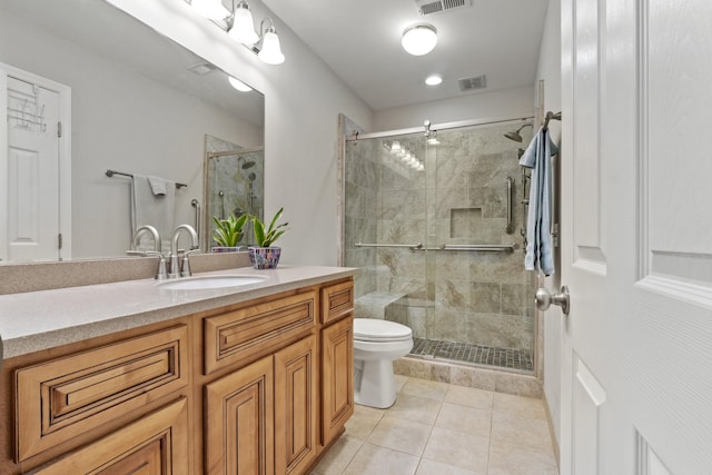 bathroom featuring visible vents, vanity, toilet, tile patterned floors, and a stall shower