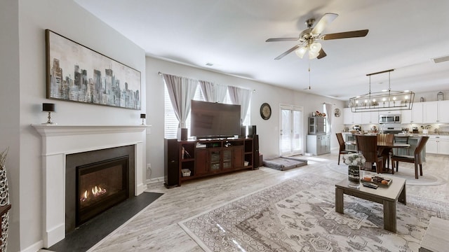 204 Princeton Dr, Lebanon, TN 37087 - living area with light wood-type flooring, ceiling fan, and a fireplace with flush hearth