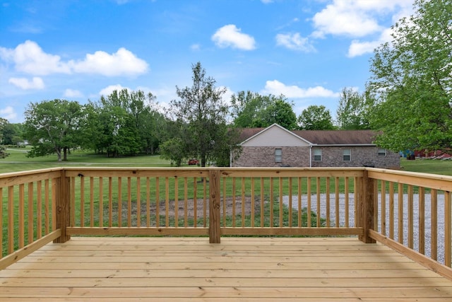 wooden terrace featuring a lawn