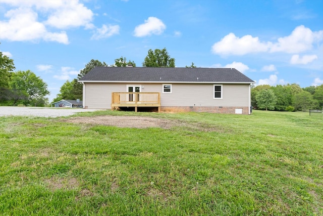 back of property with a yard, crawl space, and a wooden deck
