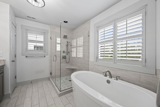 802 Montrose Ave, Nashville, TN 37204 - bathroom with visible vents, a shower stall, a soaking tub, and vanity