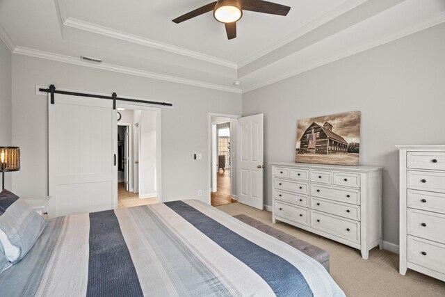 1006 Grider Dr, Gallatin, TN 37066 - bedroom with a tray ceiling, a barn door, ornamental molding, light carpet, and baseboards
