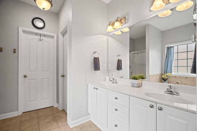 1006 Grider Dr, Gallatin, TN 37066 - bathroom with baseboards, double vanity, tile patterned floors, and a shower