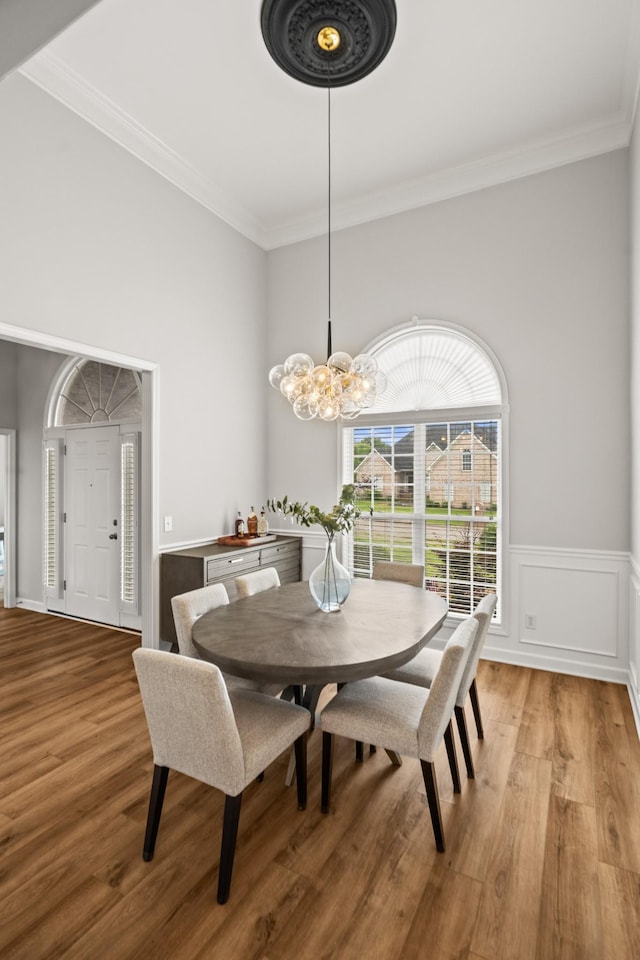 1006 Grider Dr, Gallatin, TN 37066 - dining space with light wood-type flooring, crown molding, a chandelier, and a high ceiling