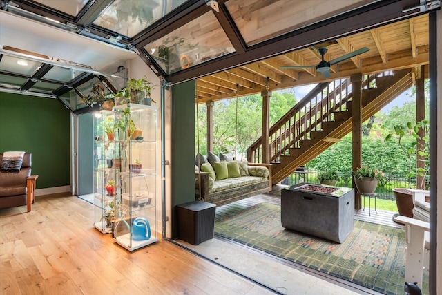 interior space with wood-type flooring, a ceiling fan, and a healthy amount of sunlight