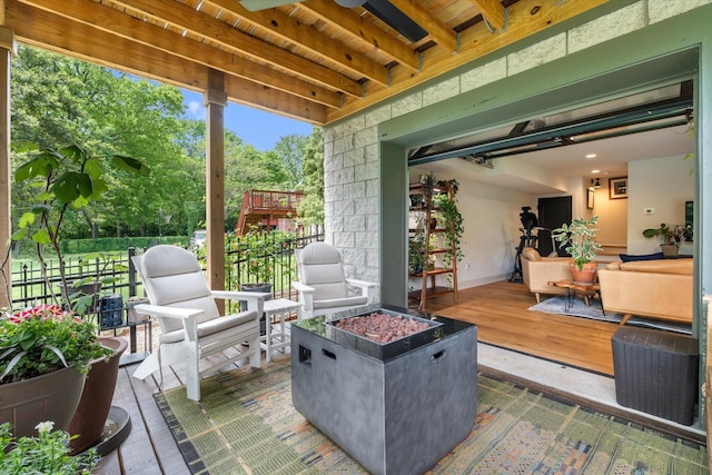 view of patio / terrace with a deck and fence