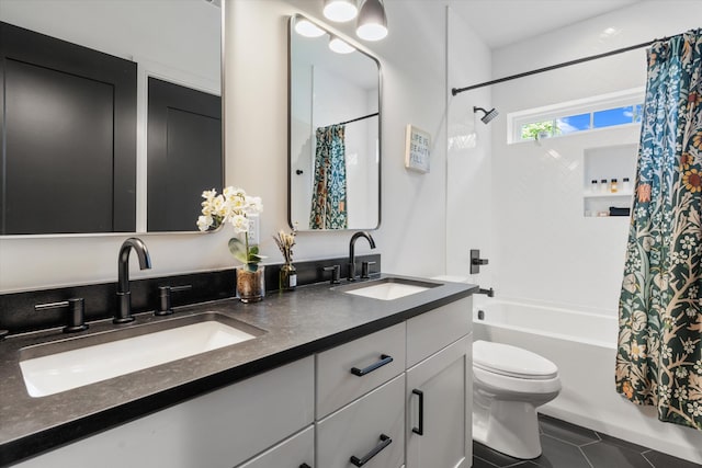 full bath featuring tile patterned flooring, a sink, shower / bath combination with curtain, and toilet
