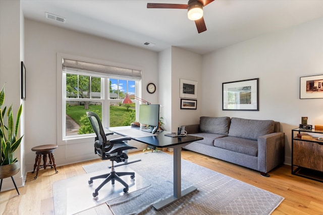 office area featuring light wood-type flooring and visible vents