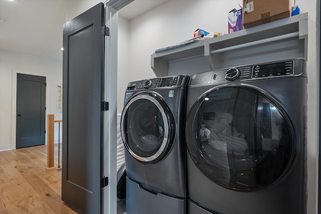 laundry room with light wood-style floors, laundry area, and washer and dryer