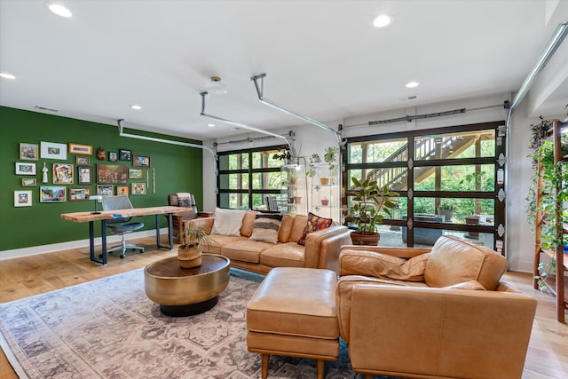 living area featuring baseboards, recessed lighting, wood finished floors, and visible vents