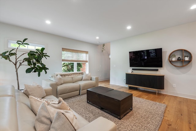 living area with recessed lighting, baseboards, and light wood-style floors