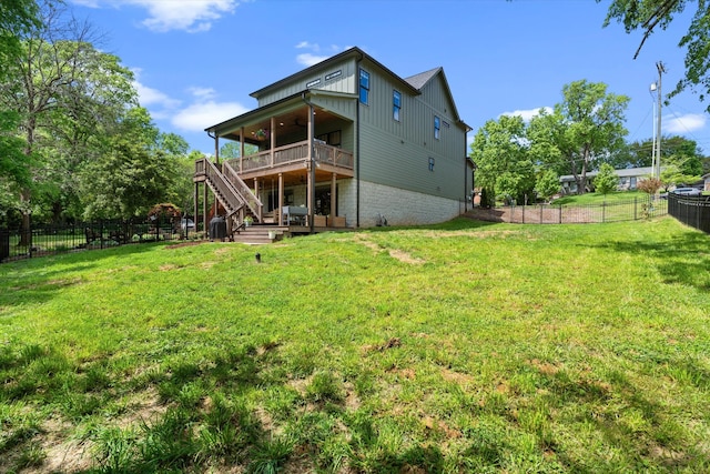 back of house featuring a fenced backyard, ceiling fan, board and batten siding, and stairway