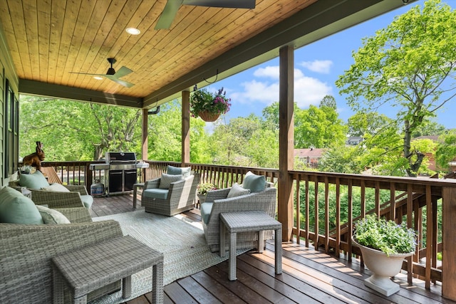 wooden deck featuring area for grilling, ceiling fan, and an outdoor living space