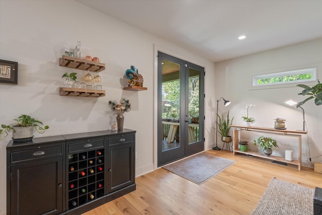 doorway to outside with light wood-type flooring, recessed lighting, baseboards, and french doors