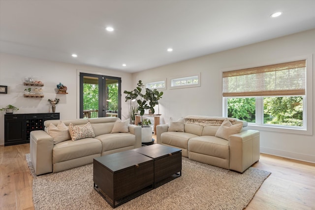 living area with french doors, recessed lighting, light wood finished floors, and baseboards
