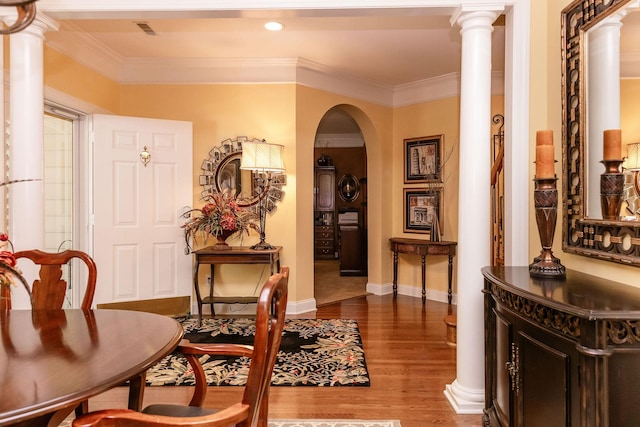 interior space with recessed lighting, arched walkways, wood finished floors, and ornamental molding