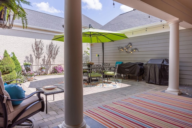 view of patio with area for grilling, fence, and outdoor dining area